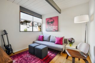A bedroom/office is colorfully decorated.