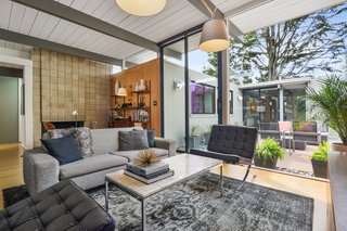 The original cinder-block fireplace anchors the living room.