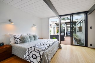The courtyard-adjacent master bedroom enjoys visual and functional integration with the outdoors.