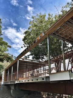 Dan Brunn Architecture and Dwell Break Ground on Bridge House in L.A. - Photo 1 of 6 - All on one level, Bridge House spans 210 feet across a stream in Hancock Park, Los Angeles. The structural undertaking was made possible by steel framework fabricated by BONE Structure.