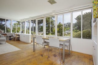 The sleek lines, corner window, and prioritization of volume over ornamentation are expressions of International Style, which have been integrated into the home.