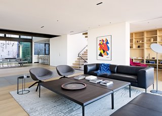 The living room, positioned centrally on the second floor, has access to both the private backyard and northern city views.