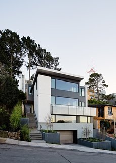 Earthy, organic materials were favored in the home's composition. The exterior palette features Pietra Serena limestone, color-integral stucco, metal panels, and stained cedar.