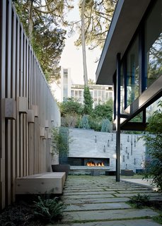 "The creation of a 'functionally active' series of retaining walls with our colleagues at Surfacedesign activates the space for use with an outdoor fireplace, bar-b-que, and climbing wall," notes Maniscalco.