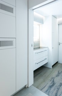 One of two bathrooms is tucked into the back corner of the home. The bathroom walls are among the only permanent walls in the entire apartment.