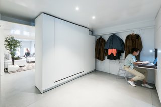 The second of two bedrooms includes a hidden desk, a fold-out bed, and ample storage.
