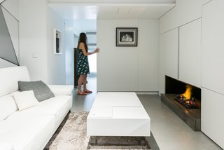 When closed, the wall adjacent to the central living room can create an additional bedroom.