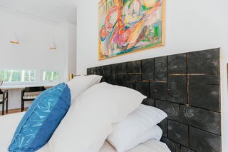 Some of the same local wood that was harvested for the stairs was cut up, charred, and made into the bedroom’s custom headboard.