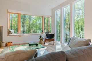 A cozy white oak window bench sits beneath an impressive Marvin Contemporary Corner Window, overlooking beautiful southwest vistas. This southern vantage point, and the window nook in particular, was a cornerstone of the home’s design and orientation.