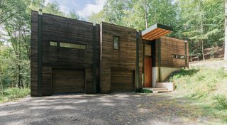 Positioned on a sloping hillside, the home is built into the land. The lower level is reserved for Marica and Brock’s "play" space, a workshop and garage, while the upper level houses the bright and airy living quarters.