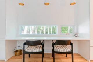 The "desk window" features small, horizontal openings which frame curated views of the trees beyond. Marvin Direct Glaze windows, and Ultimate Clad Casements make the quiet, reflective vantage point possible.