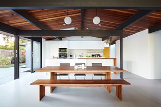The new dining room is part of the open-concept great room. Porcelanosa floor tile (in 12" x 24" Town Niquel Nature) is used throughout the home’s interior to provide a soft and neutral backdrop, allowing pops of color and statement tile to shine.
