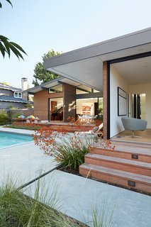 This newly built residence by Klopf Architecture was inspired by midcentury modern houses—in particular, Eichlers. The home's indoor/outdoor nature is accentuated by wood siding and lush landscape design.