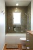 Modern home with Wood Counter, Vessel Sink, Corner Shower, Recessed Lighting, Medium Hardwood Floor, Ceiling Lighting, Wall Lighting, Enclosed Shower, Freestanding Tub, Ceramic Tile Wall, One Piece Toilet, and Bath Room. Guest Photo 4 of South Land Park