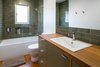 Modern home with Wood Counter, Enclosed Shower, Ceiling Lighting, Medium Hardwood Floor, Recessed Lighting, Wall Lighting, Ceramic Tile Wall, Drop In Sink, Alcove Tub, Two Piece Toilet, and Bath Room. Guest Photo 5 of South Land Park
