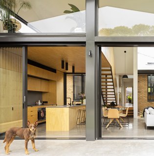 A binary play of considered honey and gray tones strongly reference the exterior yellow brick and gray metal of the two distinct structures.