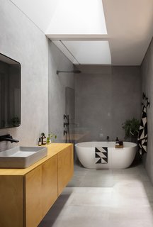 Here is the main bathroom located at the rear of the original dwelling's footprint. This area boasts an acrylic render finish to the walls, as well as a vaulted skylight that has been carved within the original roof.