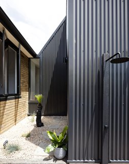 The northern courtyard provides a secondary entry, as well as an outdoor shower.