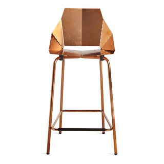 A copper-plated finish coats this counter stool by Blu Dot, which ships flat and folds along laser-cut lines to create a dynamic chair. 