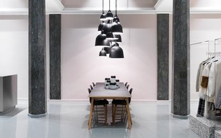 Bell lamps in various sizes hovering above the Slice table.