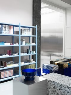 The showroom's display podiums are made of mirrored glass, steel, acrylic, and terrazzo.
