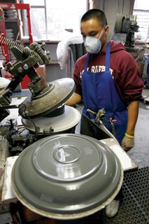 This plate is formed on an automated jigger machine. It will remain on the mold until it dries.