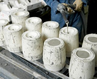 Liquid clay (slip) is poured into the mold until it fills to the top. After a wall thickness dries, the remainder of the slip is poured out, and can be reused in the next pour.