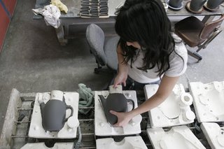 After sitting for about half an hour the clay is firm enough that the cast forms can be removed from the molds. More drying is required before the pieces can be trimmed.