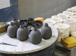 The vases need to be trimmed and wiped in order to remove the mold seam.