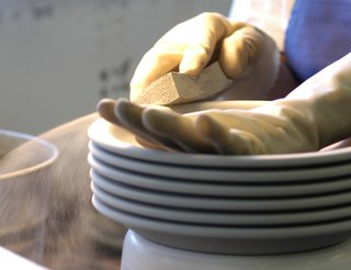 Each piece is wiped with a wet sponge to smooth the surface.
