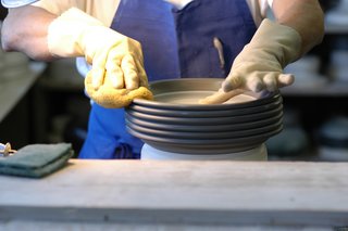 After trimming, the final step before glazing is wiping down the piece with a wet sponge. This smooths the surface and gives it a hand-finished texture.