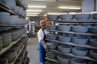 Trimmed pieces are placed on wheeled carts and moved to the next process. These pieces are trimmed, dry and ready for glazing.