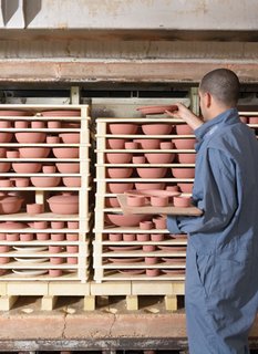 The pieces are stacked like a puzzle, using kiln furniture, into our top-hat kilns.