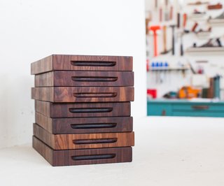 A stack of finished walnut butcher blocks sits in his studio. Dave carefully reads the grain of the wood to create beautiful patterns. On average, each piece takes about 5 hours to make from start to finish.