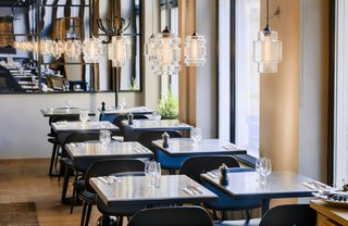 Guests Enjoy Meal Under Modern Restaurant Pendant Lighting in Sweden - Photo 1 of 3 -