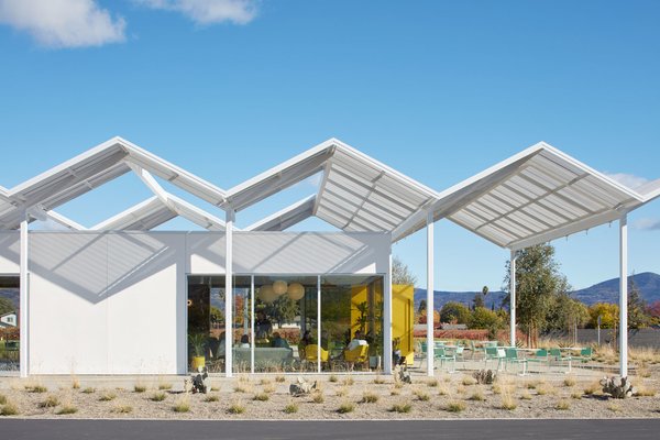 The tasting room is shaded by a folded plate canopy that recalls the modernist designs of architect Donald Wexler.