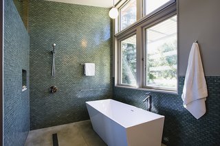Solar hot water panels provide domestic hot water for the house, and the pool. The master bath receives daylight from two sides through the high transom windows.