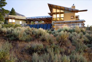 The earth finish, slatted cement board siding, and metal roofing harmonizes with the landscape and take advantage of the changing desert light.
