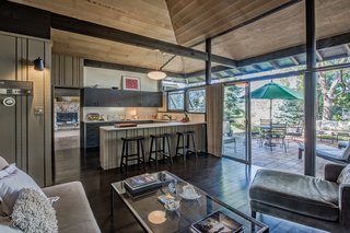 Brilliantly designed by architect James E. Norman, this home is striking and one-of-a-kind. The rock wood-burning fireplace, curved rock wall entrance and exposed post and beam construction all lend themselves to defining this mid-century modern's wholly unique style.