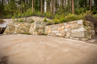 A 15th-generation stone mason was brought from Japan to construct the expansion's 185-foot-long, 18.5-foot-high "castle wall." The Baker Blue granite stones sourced from Baker City, Oregon, were handpicked and hand-laid with a seismically-safe traditional technique. Interestingly, the artisan was very excited about this project as he had never actually built a new wall—in Japan, his work consists of repairing ancient structures.