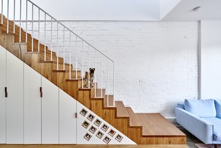 The High House in Melbourne by Dan Gayfer integrates storage cabinets and a wine rack into the staircase. 