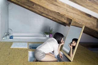 The bathroom in the bedroom loft of this Spanish apartment by Elil sneaks a sunken bath as and extra storage for toiletries and a vanity mirror into the floor. 