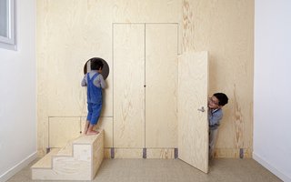 For this family home in Geneva, architect Aurelie Monet Kasisi designed a series of bookshelves that act as walls. dividing two large rooms into four smaller ones. 