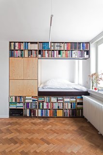 This renovation for a writer in Prague by BY Architects has slotted the bed behind a massive bookshelf in order to meet spatial requirements. 