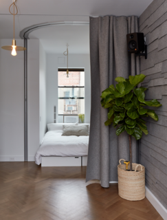This 350-square-foot prototype house designed by Graham Hill, the founder of the eco-lifestyle website Treehugger, features a guest room that can also be transformed into an office or a bar—then discretely concealed behind a gray felt curtain that offers guests privacy. 