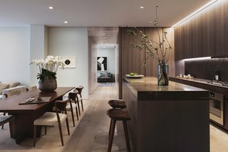Dinesen wood doors have been designed to seamlessly pocket into corridor walls. When closed, they section off the master bedroom and bath to create a seamless entertaining space. 