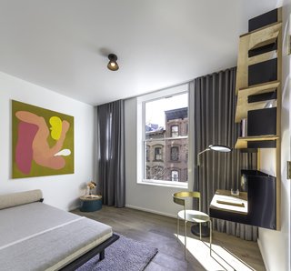 The second bedroom boasts Matter Made’s mounted desk with shelving units designed by Henry Julier, paired with a brass Avoa chair designed by Pedro Paulø-Venzon—also from Matter Made. A Vonnegut Kraft Crescent Lounge daybed completes the space.