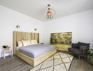 The master bedroom includes a stunning multicolor glass lighting fixture by New York-based lighting and product designer Bec Brittain, which creates a soothing ambiance and an artistic focal point in the room.