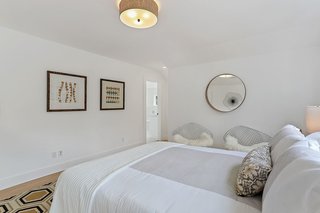 Upstairs, the bedrooms boast walk-in closets and en-suite bathrooms. A whole-house filtration system provides purified water from every tap. 
