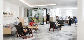 Designed for 60 employees, the office provides various work configurations and spaces that include sit-stand desks, private phone booths, and a hospitality lounge. All of the spaces are configured for communal working and employees can sit at large custom-designed tables. This facilitates interaction in a way that individual desks cannot.